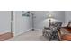 Cozy sitting area featuring a patterned arm chair and view into the adjacent laundry room at 5812 Solitude Way, Durham, NC 27713