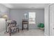 Sitting area featuring a vintage desk and a large potted plant near the window at 5812 Solitude Way, Durham, NC 27713
