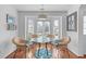 Cozy dining area features a glass table, four chairs, and natural light from bay windows at 5812 Solitude Way, Durham, NC 27713