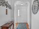 Bright entryway with wood floors, decorative art, and a view of the double front doors at 5812 Solitude Way, Durham, NC 27713