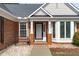 Inviting home entry features a classic door with sidelights, brick accents, and a cozy front bench at 5812 Solitude Way, Durham, NC 27713