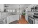 Modern kitchen with stainless steel appliances, light granite countertops, and hardwood flooring at 5812 Solitude Way, Durham, NC 27713