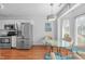 Eat-in kitchen features stainless steel appliances, white cabinets, and a pendant light fixture at 5812 Solitude Way, Durham, NC 27713