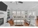 Well-lit living room showcasing hardwood floors, a fireplace, and comfortable seating arrangements at 5812 Solitude Way, Durham, NC 27713