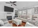 Bright living room featuring a fireplace, built-in shelving, hardwood floors and neutral-toned furnishings at 5812 Solitude Way, Durham, NC 27713