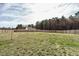 Spacious backyard with a wood fence, view of trees, and a lush green lawn at 59 Peduncle St, Selma, NC 27576