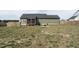 View of backyard featuring a screened porch, green siding, and fire pit at 59 Peduncle St, Selma, NC 27576