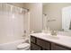 Bathroom featuring a shower-tub combo, a dark vanity, and a white ceramic toilet at 59 Peduncle St, Selma, NC 27576