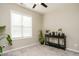 Empty room with ceiling fan and large window is perfect for a home office, spare bedroom, or playroom at 59 Peduncle St, Selma, NC 27576