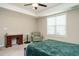 Comfortable bedroom features a ceiling fan, a cozy chair, and a bedside table for a relaxing retreat at 59 Peduncle St, Selma, NC 27576