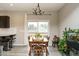 Bright dining area features laminate wood floors, sliding door access to the deck, and bar seating for entertaining at 59 Peduncle St, Selma, NC 27576