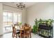 Sunlit dining room features sliding glass doors to screened-in porch and views of the backyard and an aquarium at 59 Peduncle St, Selma, NC 27576