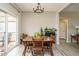 Dining area with backyard view, features laminate flooring, natural light and a dining table with seating for four at 59 Peduncle St, Selma, NC 27576