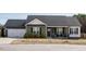 Charming single-story home with a well-manicured lawn, a two-car garage, and a covered front porch at 59 Peduncle St, Selma, NC 27576