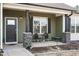 Inviting covered front porch with stone pillars and seating area, perfect for relaxing and enjoying the outdoors at 59 Peduncle St, Selma, NC 27576