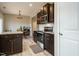Kitchen with dark cabinets, stainless steel appliances, and adjoining dining area offers modern convenience at 59 Peduncle St, Selma, NC 27576