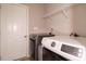 Laundry room features modern washer and dryer, overhead wire shelving, and white door at 59 Peduncle St, Selma, NC 27576