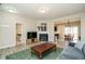 Bright living area adjacent to dining room showcases the open layout; featuring fireplace, laminate floors, and plush sofa at 59 Peduncle St, Selma, NC 27576