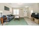 Comfortable living room featuring a plush sofa, neutral walls, and laminate flooring, perfect for relaxation and entertainment at 59 Peduncle St, Selma, NC 27576