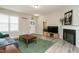 Cozy living room featuring a fireplace, plush green carpet, and neutral paint, creating a warm and inviting atmosphere at 59 Peduncle St, Selma, NC 27576