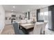 Open dining room with view of the kitchen, dark wood table, and seating for six at 6028 Sodium St, Raleigh, NC 27610
