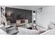 Cozy living room with accent wall, plush seating, television, area rug and natural light at 6028 Sodium St, Raleigh, NC 27610