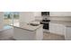 Modern kitchen with granite countertops, stainless steel appliances, white cabinets, and island sink at 6032 Sodium St, Raleigh, NC 27610