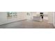Open living space with modern flooring, a view to the outdoors, and a kitchen with an island at 6032 Sodium St, Raleigh, NC 27610