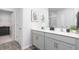 This bathroom features a double sink, framed art and modern fixtures at 6045 Sodium St, Raleigh, NC 27610