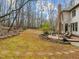 Spacious backyard featuring a lush lawn, stone accents, and a cozy patio at 6106 Bent Oak Dr, Durham, NC 27705