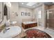 Luxurious bathroom featuring a soaking tub, walk-in shower, and double vanities at 6106 Bent Oak Dr, Durham, NC 27705