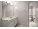 Bright bathroom with white vanity, framed mirror, and views to another bathroom at 6106 Bent Oak Dr, Durham, NC 27705