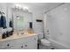 Well-lit bathroom featuring a framed mirror, and a open door frame to the bath tub at 6106 Bent Oak Dr, Durham, NC 27705