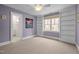 Bright bedroom with light purple walls, built-in shelves, and large window at 6106 Bent Oak Dr, Durham, NC 27705