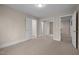 Bedroom with open mirrored closet, and a door frame to another room at 6106 Bent Oak Dr, Durham, NC 27705