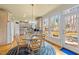 Eat-in kitchen area with glass-top table, wood chairs, and bright natural light looking into kitchen at 6106 Bent Oak Dr, Durham, NC 27705