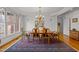 Bright dining room featuring a wooden table, chandelier, and large windows at 6106 Bent Oak Dr, Durham, NC 27705