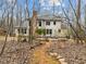 Backyard view with stone walking path, stone patio, and lush landscaping at 6106 Bent Oak Dr, Durham, NC 27705