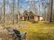 Brick home surrounded by mature trees and lush green landscaping, creating a private and inviting atmosphere at 6106 Bent Oak Dr, Durham, NC 27705