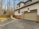 Side view of the home showcasing the garage, driveway, and landscaping at 6106 Bent Oak Dr, Durham, NC 27705