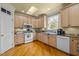 Charming kitchen featuring light wood cabinets, granite countertops, and modern appliances at 6106 Bent Oak Dr, Durham, NC 27705