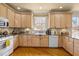 Bright kitchen boasts natural wood cabinetry, sleek countertops, and a garden view at 6106 Bent Oak Dr, Durham, NC 27705