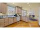 Charming kitchen with light wood cabinetry, granite countertops, and adjacent breakfast nook at 6106 Bent Oak Dr, Durham, NC 27705
