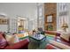 Bright living room with stone fireplace, hardwood floors and view into eat-in kitchen at 6106 Bent Oak Dr, Durham, NC 27705