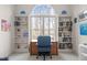 Bright office with a large window, built-in shelves, wood desk, and a comfortable office chair at 6106 Bent Oak Dr, Durham, NC 27705