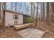 Exterior view of the outbuilding with a deck and surrounding trees at 6106 Bent Oak Dr, Durham, NC 27705