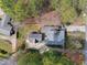 An aerial view of the property showcasing its landscaped yard, mature trees, and roof at 6301 King Lawrence Rd, Raleigh, NC 27607
