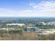 An aerial view of a well-placed property surrounded by lush greenery and nearby cityscape at 6301 King Lawrence Rd, Raleigh, NC 27607