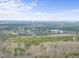 Expansive aerial perspective featuring a lush green forest and scattered commercial properties at 6301 King Lawrence Rd, Raleigh, NC 27607