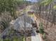 Aerial view of a cozy home nestled in a wooded area, surrounded by mature trees and greenery at 6301 King Lawrence Rd, Raleigh, NC 27607